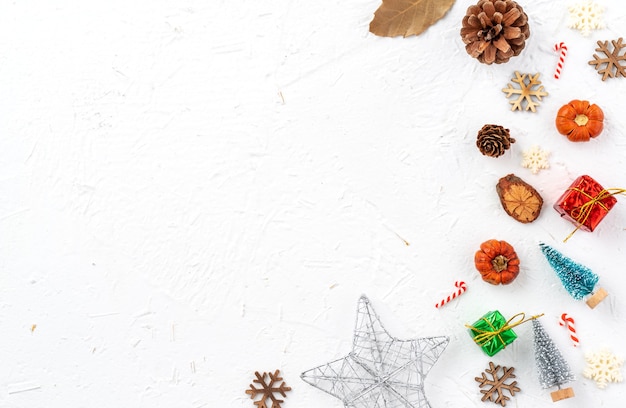 Top view of Christmas holiday decoration ornament composition with Christmas tree, gift star, gingerbread man flat lay with copy space isolated on white background.