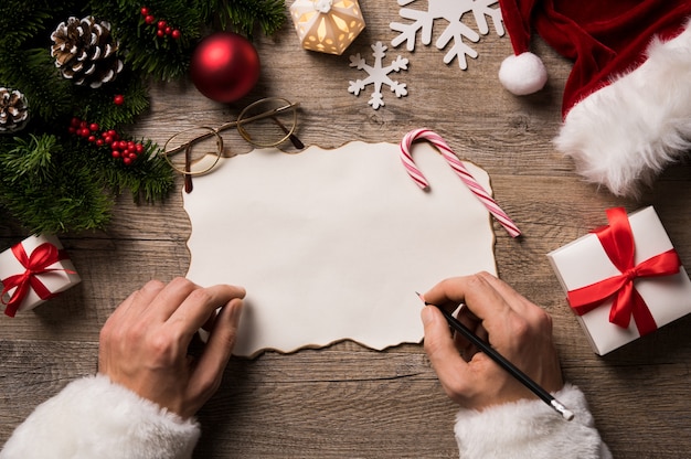 Top view of christmas letter in santa claus hand.