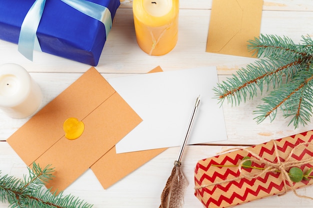 Top view of Christmas letter writing on yellow paper on wood with decorations