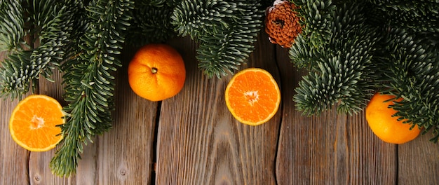 Top view of Christmas spruce tree and tangerines