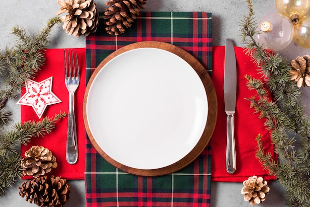 Top view of christmas table arrangement with plate and cutlery