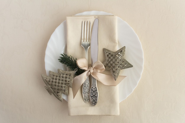 Top view of Christmas table setting on the beige tablecloth