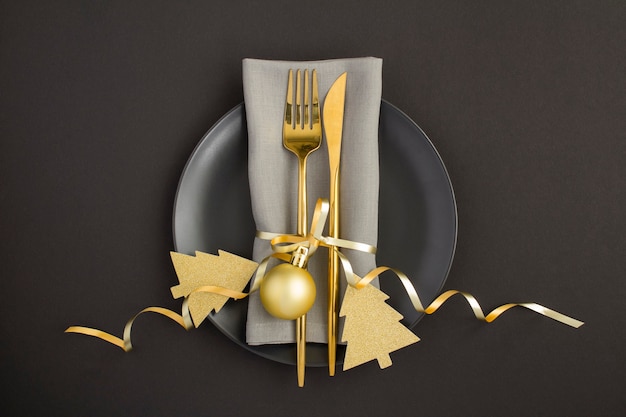 Top view of Christmas table setting on the black plate