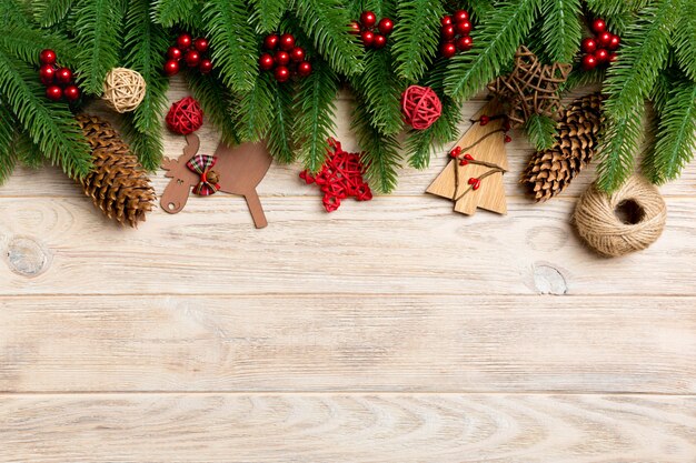 Top view Christmas toys, decorations and fir tree branches on wooden .   holiday   copyspace