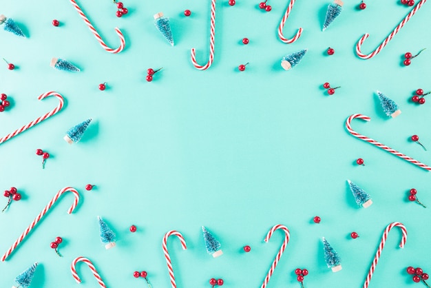 Top view of Christmas tree decoration on green pastel