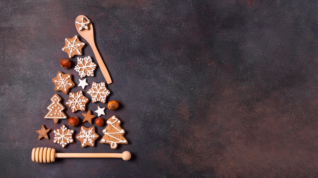 Photo top view of christmas tree shape made of gingerbread cookies and kitchen utensils with copy space
