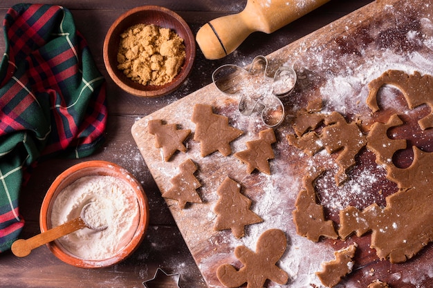 Top view of christmas trees cookie dough with rolling pin