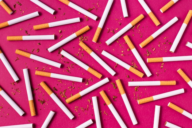 Top view cigarettes on pink background