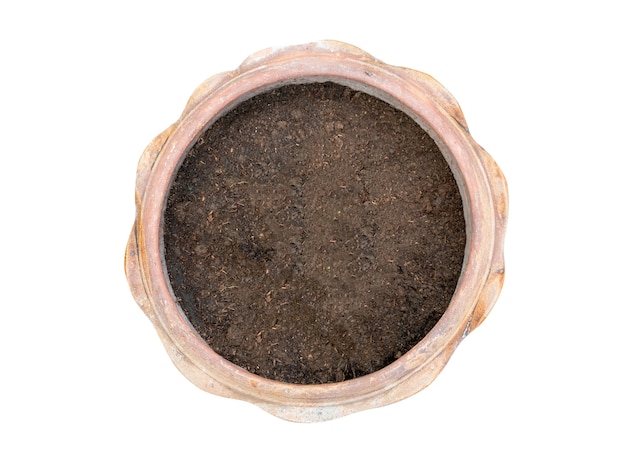 Top view of a clay pot filled with organic potting soil on a white background.