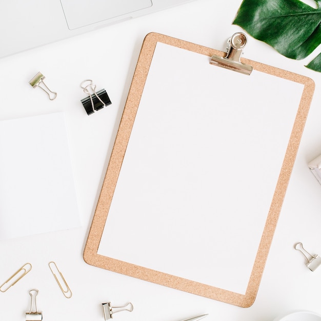 Top view on clipboard and palm leaf