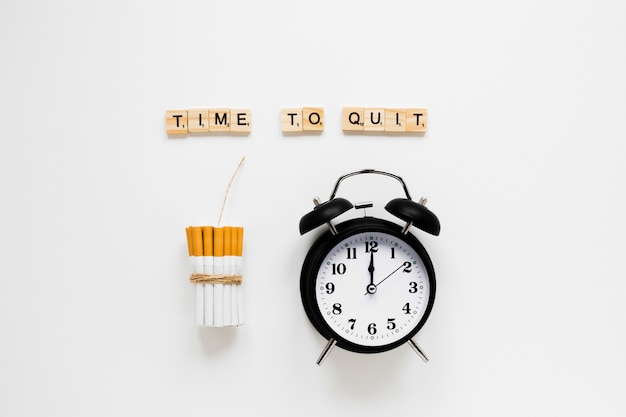 Photo top view clock with cigarettes and words