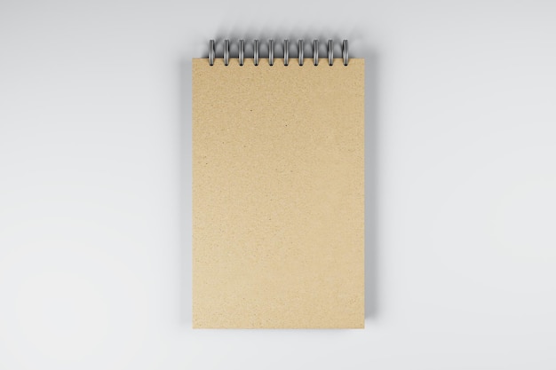 Top view and close up of brown spring notepad on white desktop background Mock up place for your advertisement Education work supplies and stationery concept 3D Rendering