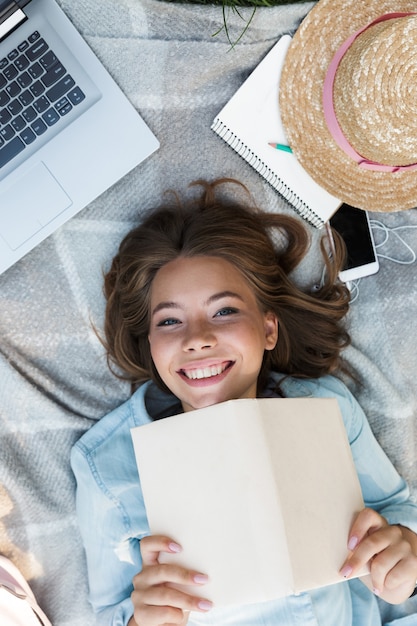 Top view close up of a happy young teenage girl laying