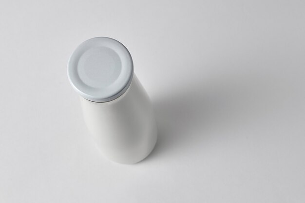 Top view of a closed bottle with fresh milk