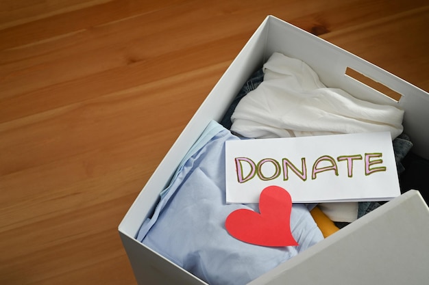 Фото Смотреть верхнюю часть одежда пожертвовать коробку с одеждой с этикеткой пожертвования приготовление использованной старой одежды дома