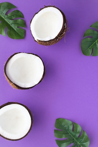 Top view of coconut halves and palm leaves