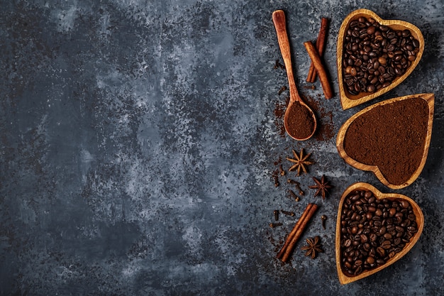 Top view of coffee beans, ground coffee and spices.