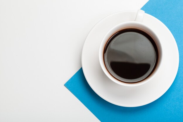 Top view of a coffee cup on a blue and white surface