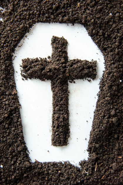 Top view of coffin shape with brown soil white wall