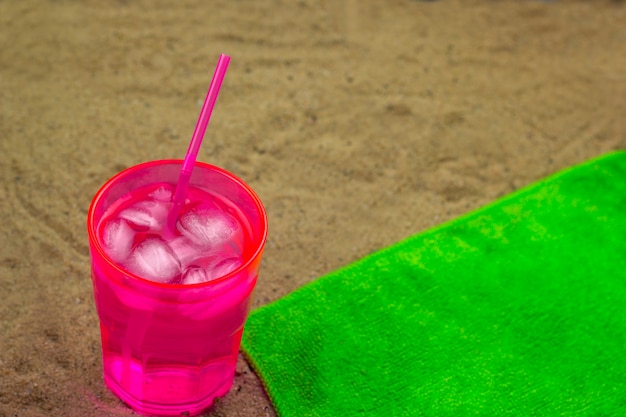 Top view cold coctail on a green towel on a bech