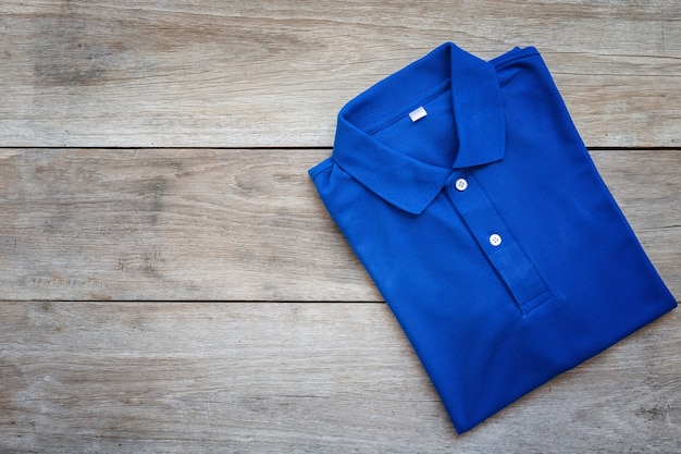 Top view of color T-Shirt on grey wood plank background