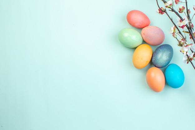 top view colored easter eggs on blue surface