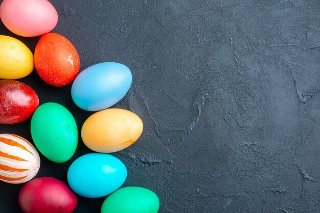 top view colored easter eggs on dark surface