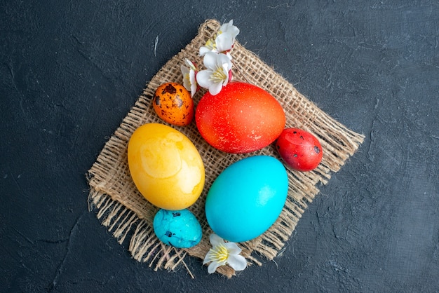 top view colored easter eggs on dark surface