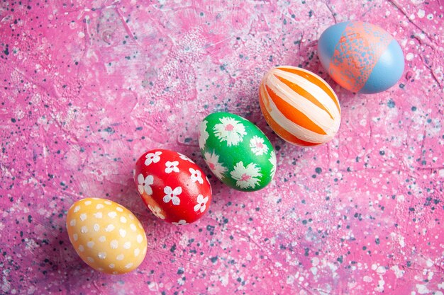 top view colored easter eggs lined on pink surface spring colour colourful concept ornate easter holidays