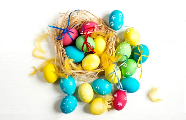 Top view of colored easter eggs on white background