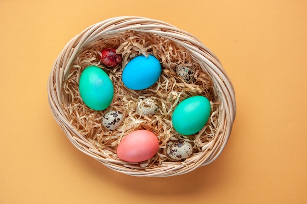вид сверху цветные крашеные яйца внутри корзины на желтой поверхности праздник весна красочная концепция новруз этнический богато