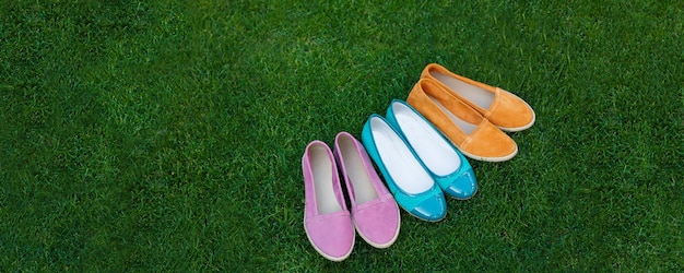 Top view of colored shoes on the grass