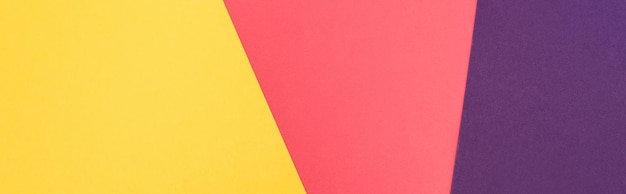 Top view of colorful abstract yellow purple and pink paper background panoramic shot