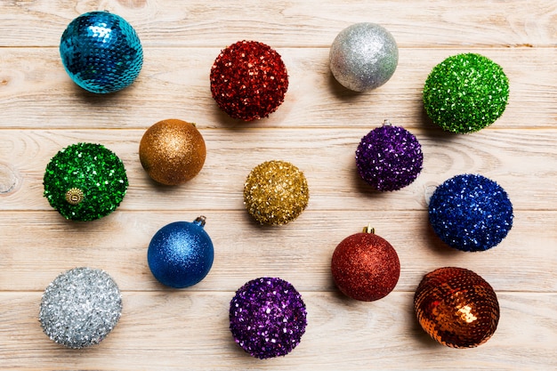 Top view of colorful Christmas balls on wooden background