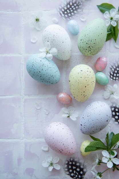 Top view of colorful easter eggs on pink tile background