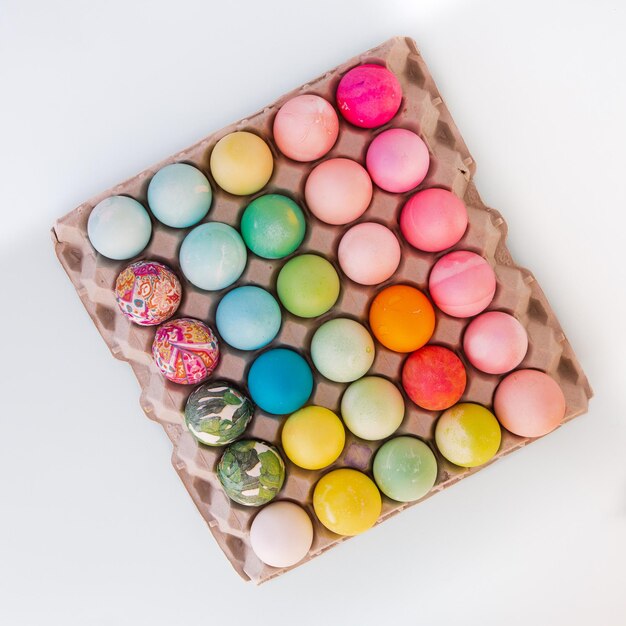 Top view of colorful easter eggs on white background