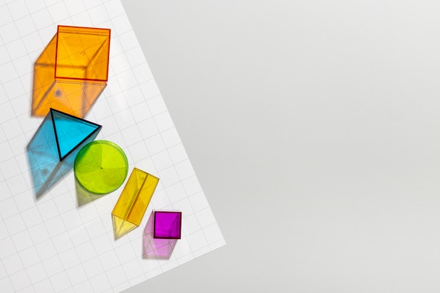 Top view of colorful geometric forms with copy space