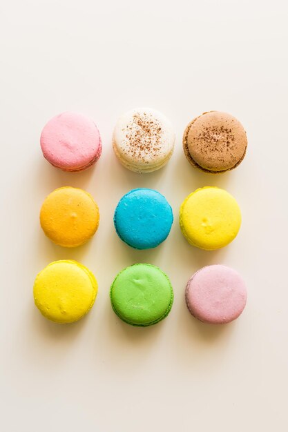 Top view of colorful macarons on a white table