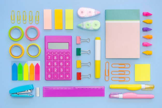 Top view of colorful office stationery with calculator and stapler