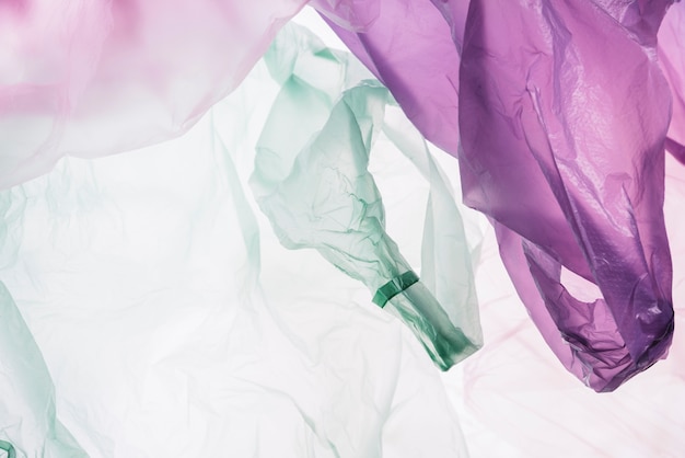 Top view colorful plastic bags on white background