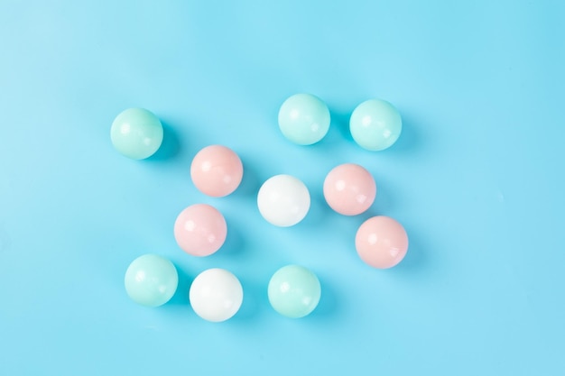 Top view of colorful plastic balls on blue background