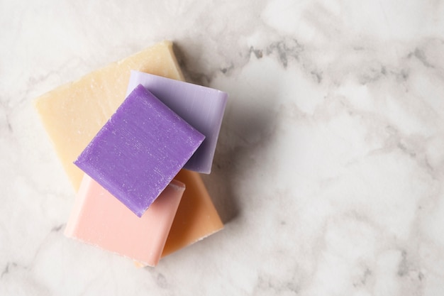 top view colorful soaps on marble background