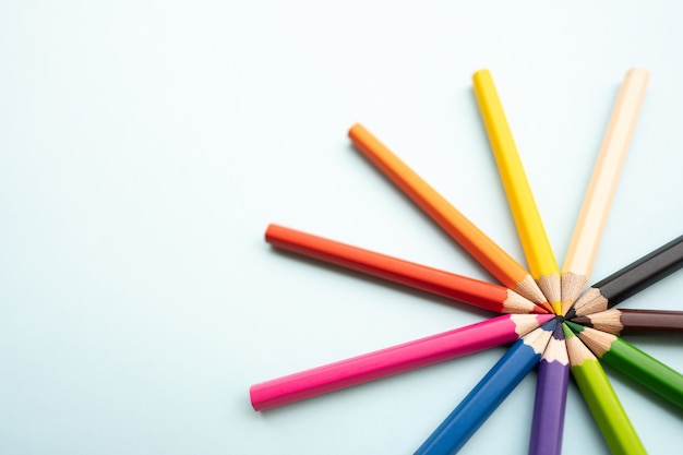 Top view of colourful crayons or colour pencil set in range