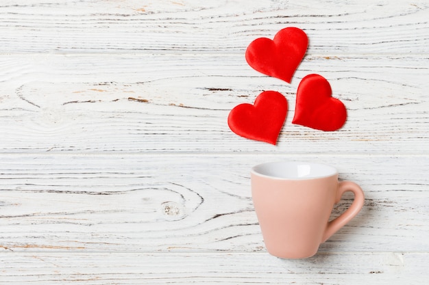 Photo top view composition of hearts splashing out from a cup