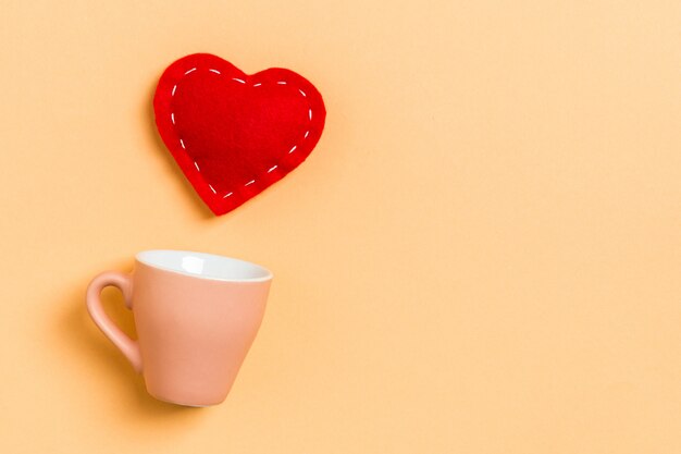 Photo top view composition of red hearts falling out from a cup