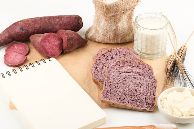 Top View Composition of Slice Homemade Purple Bread Made from Japanese Purple Sweet Potato with natural Color. Concept for Healthy Diet Bakery, Copy Space for Text or Recipe on White Background