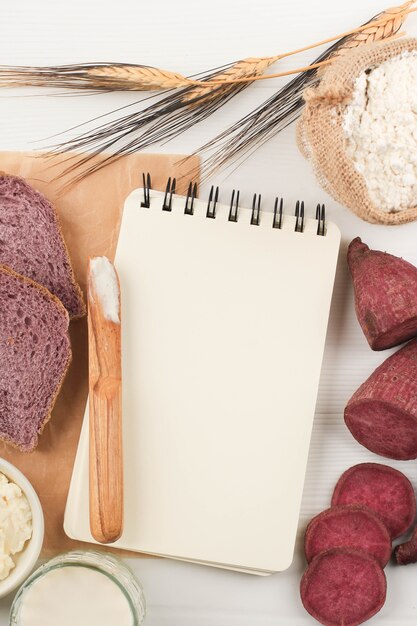 Top View Composition of Slice Homemade Purple Bread Made from Japanese Purple Sweet Potato with natural Color. Concept for Healthy Diet Bakery, Copy Space for Text or Recipe on White Background