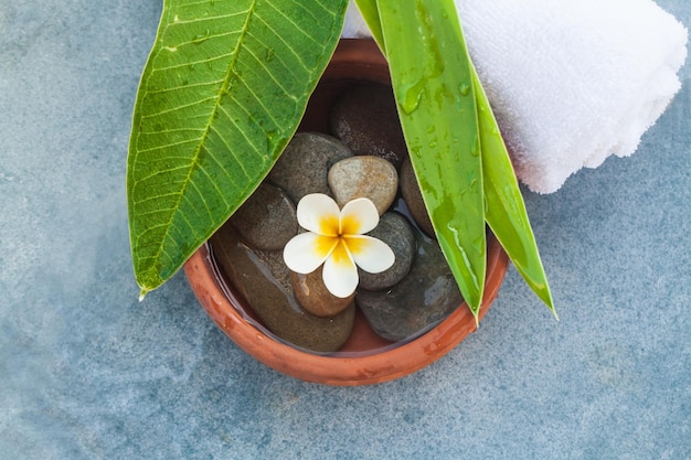 Top view on composition of spa objects and stones for massage treatment on blue