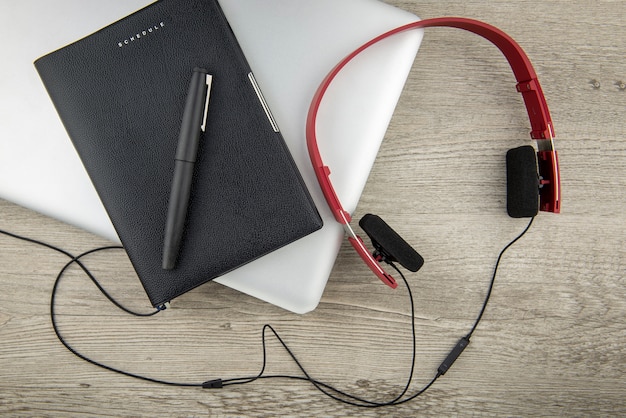 Top view of computer notebook and schedule book with pen