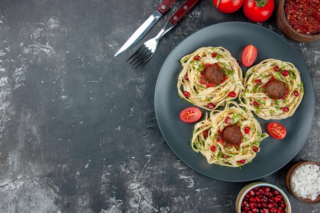 Top view cooked dough slices with meatballs on a gray background pasta meat dish dinner cooking color restaurant